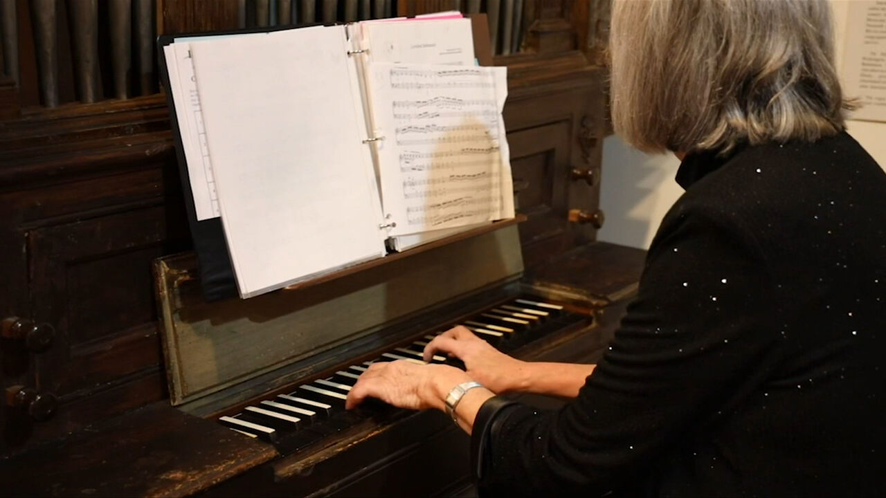 Woman playing the church organ